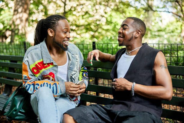 istock Casually dressed couple relaxing and talking in public park 1693335767