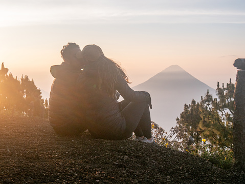They enjoy nature at sunrise, looking at the beautiful landscape. Volcan Acatenango, Guatemala