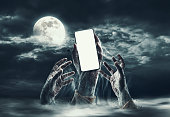 Zombie hands and smartphone with blank screen