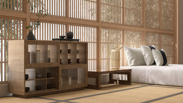 istock Wooden display cabinet, bedside table with lantern by bed, pillow on tatami mat in sunlight from shoji window with bamboo tree 1693366731