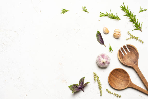 istock Food background with spices, herbs and utensil on kitchen table 1693366733