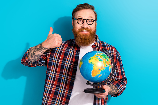 Portrait of mature student businessman discover planet earth continents geography like enjoy education isolated on blue color background.