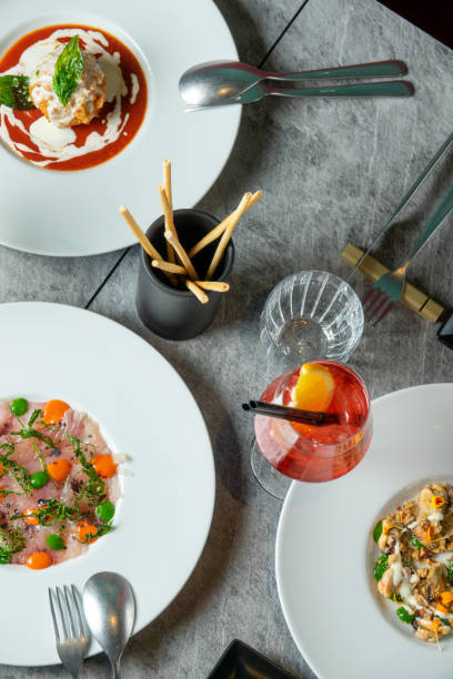 istock Top view with dishes and cocktails at the restaurant 1693376527
