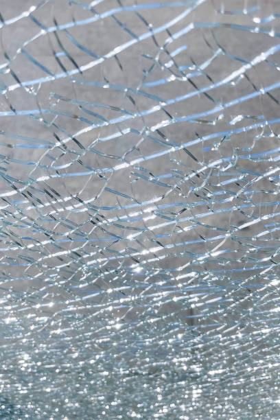 istock Broken glass on the street as an abstract background. 1693410062