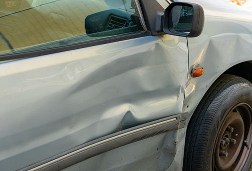 Dent in a car door after an accident