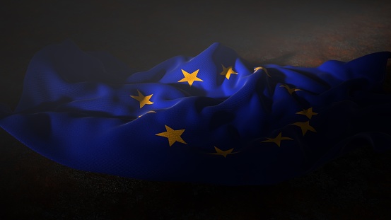 Two women standing on hill holding EU flag behind back