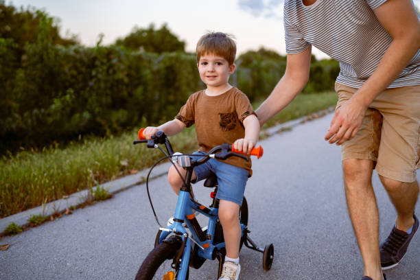 istock Father teaching his son to ride a bicycle 1693431274