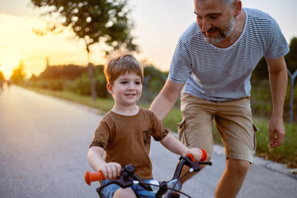 istock Father teaching his son to ride a bicycle 1693431482