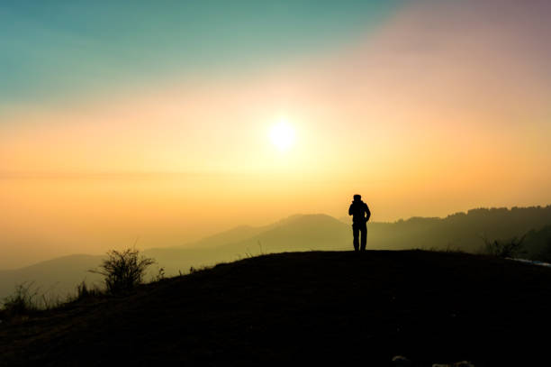 istock Backlit person looking towards the sky. 1693432253