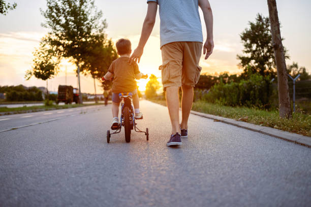 istock Father teaching his son to ride a bicycle 1693432867