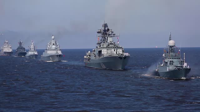 View of Russian Navy line ahead, modern russian military naval battleships warships in the row, northern fleet and baltic sea fleet, summer sunny day during the military exercise