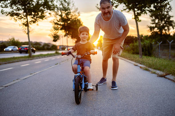 istock Father teaching his son to ride a bicycle 1693434041