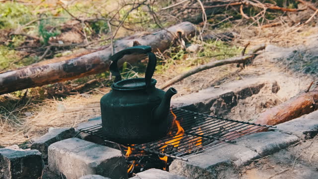 Old Kettle Standing on a Tourist Campfire in Nature