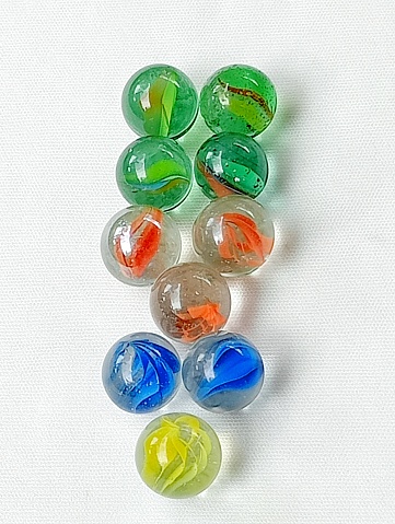 Marbles are children's toys from the 90s. Many marbles placed on 1234 on a white background.