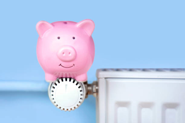 istock Pink piggy bank sits on the radiator 1693446700