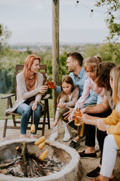 istock Friends having good time and baking corns in the house backyard 1693446721