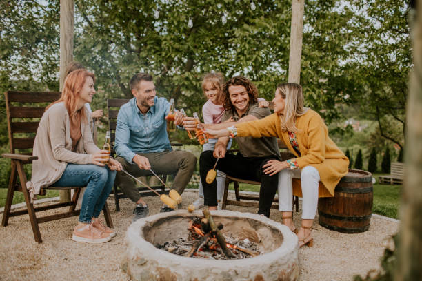 istock Friends having good time and baking corns in the house backyard 1693448418