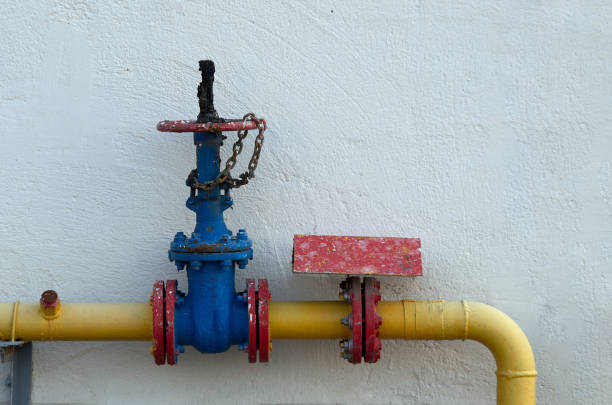 istock Gas pipe with valve on the background of a white wall 1693456080