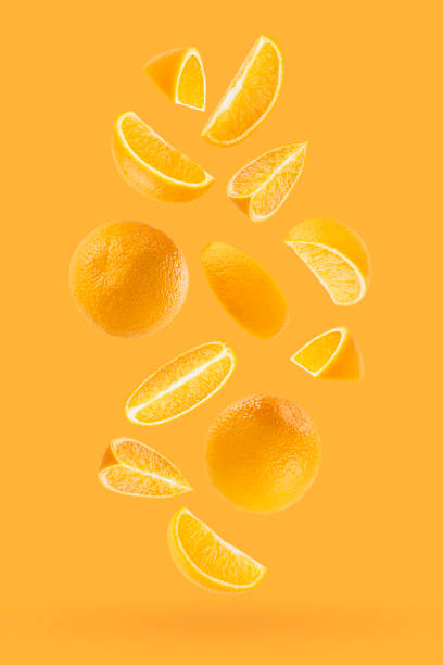 istock Juicy oranges as flow fly or fall as art composition. Whole, half, quarter pieces fruits on pastel orange background with shadow. Tropical fruits for advertising, design, label product, poster, card. 1693472514