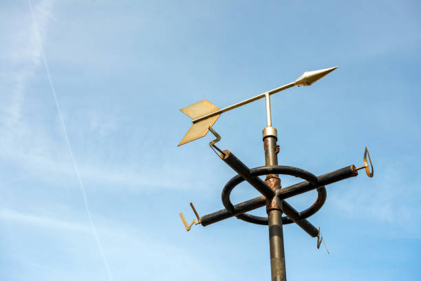 White Weathervane Against a Radiant Blue Sky