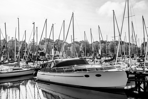Sailing yachts and fishing boats moored in marina.Netherlands.BW