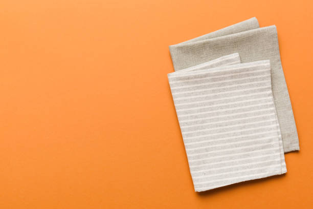 istock top view with gray kitchen napkin isolated on table background. Folded cloth for mockup with copy space, Flat lay. Minimal style 1693487535