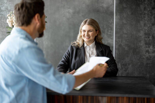 istock Medical receptionist with man at the reception desk 1693490105