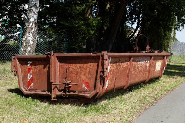 istock Old brown dumpster with plant waste standing on a meadow, Germany, Europe 1693493035