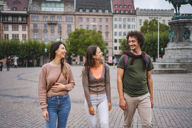 istock Three smiling tourists exploring the city of Malmo 1693493805