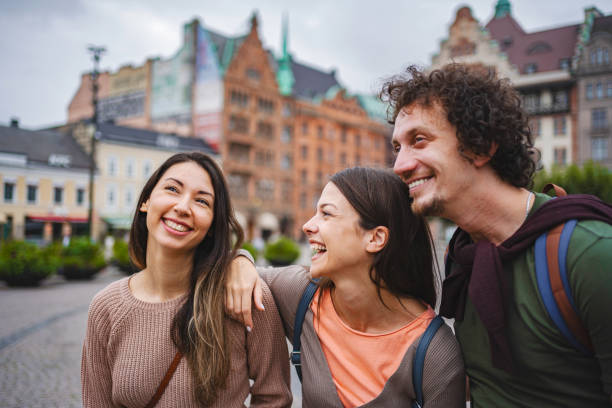 istock Three smiling tourists exploring the city of Malmo 1693493857