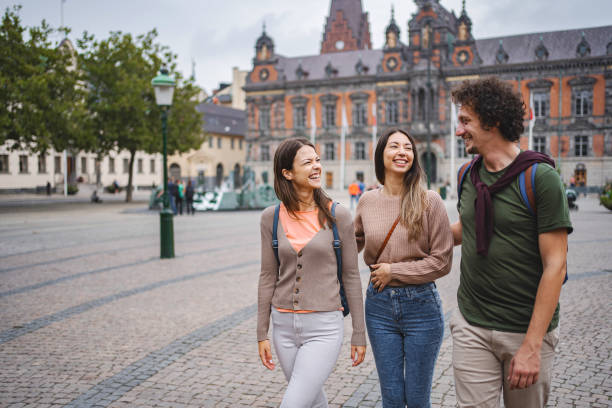 istock Three smiling tourists exploring the city of Malmo 1693493860