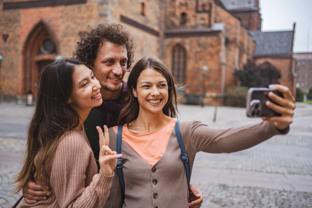 istock Three happy tourists taking selfies while exploring the city of Malmo 1693494012