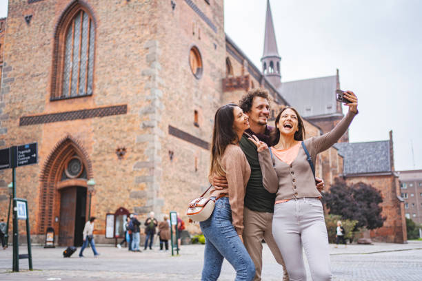 istock Three happy tourists taking selfies while exploring the city of Malmo 1693494014