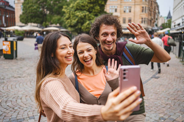 istock Three happy tourists talking on a video call while exploring the city of Malmo 1693494625