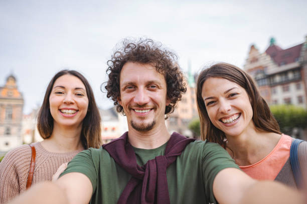 istock Happy small group of friends smiling at camera 1693496027