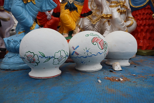 Mysuru, Karnataka, India-September 13 2023; A Close up picture of a few water pots made of clay in white colors hand painted with drawings, used during summer season in tropical Rajasthan in India.