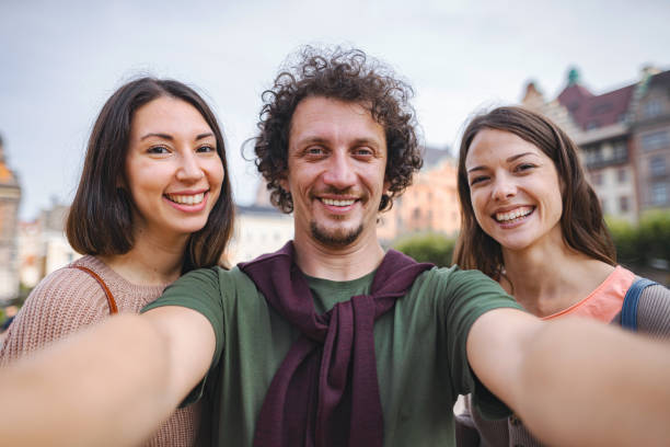 istock Happy small group of friends smiling at camera 1693496603