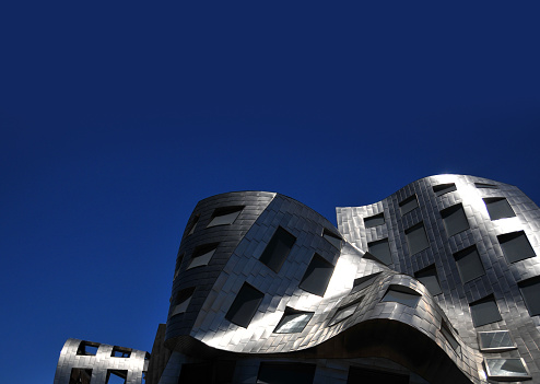 Las Vegas, Clark County, Nevada, USA: Lou Ruvo Center for Brain Health (LRCBH), aka the Cleveland Clinic Lou Ruvo Center for Brain Health - research and scientific information center for the treatment of Alzheimer's , Parkinson's and Huntington's diseases - bold design by Frank Gehry, fluid façade with metalic shingled panels and punctured with a grid of windows.