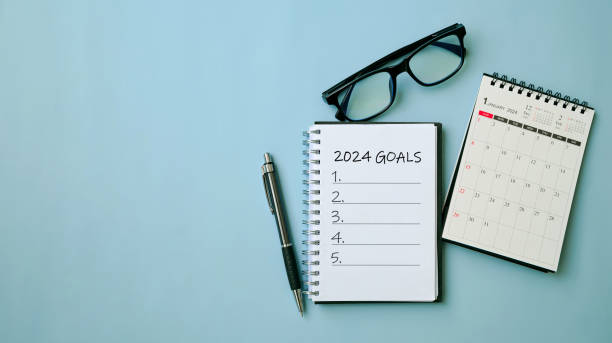 istock 2024 New Year goal, plan, and action concepts. 2024 goals Text on Note Pad with calendar, glasses on the table.New Year's resolutions plan.Happy New Year theme, top view, copy space. 1693501537