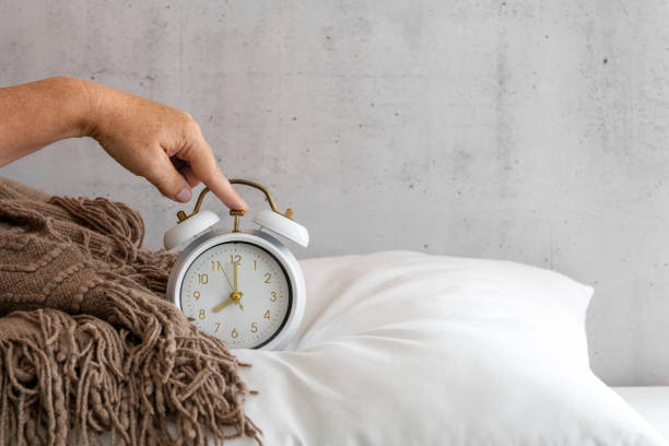 istock A hand turns off an alarm clock 1693503309