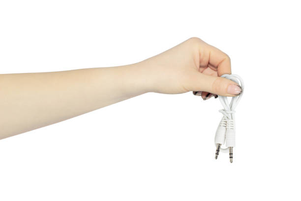 hand of young girl holding earphones. Isolated on white background