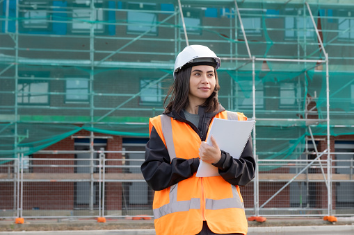 A female engineer holding a note pad