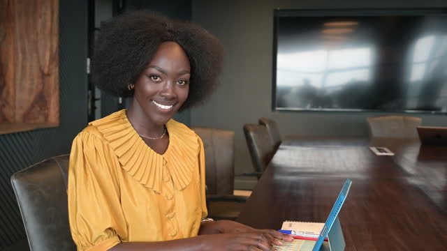 Candid portrait of African businesswoman in board room