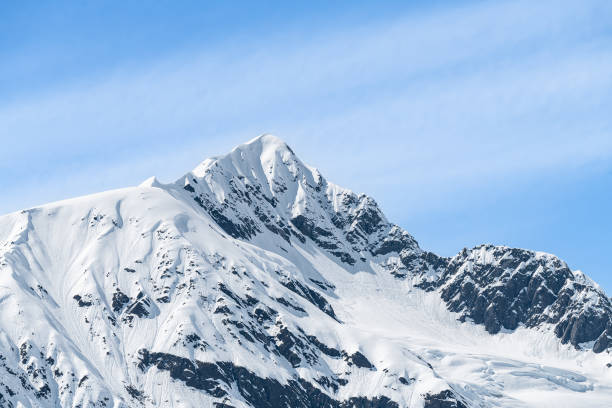 Sun and shadows on a snow covered mountain, Whittier, Alaska, USA