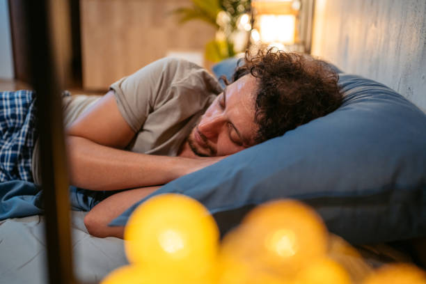 istock Young Man Sleeping In The Bed At Night 1693527366