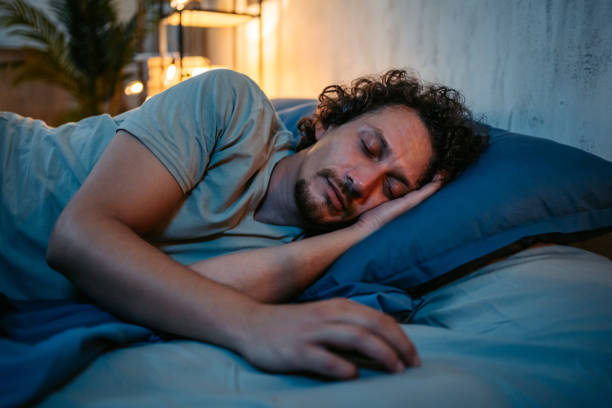istock Young Man Sleeping In The Bed At Night 1693527912