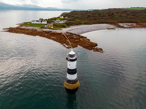 Aerial view of Penmon Lighthouse on the island of Anglesey in North Wales, United Kingdom.