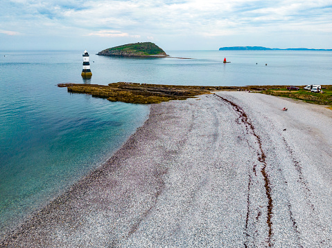 Aerial view of Penmon Lighthouse and Puffin Island on the island of Anglesey in North Wales, United Kingdom.