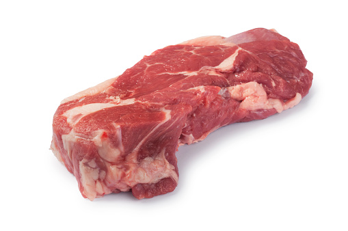 Studio shot of raw rump of lamb steaks cut out against a white background
