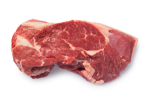 Studio shot of raw rump of lamb steaks cut out against a white background